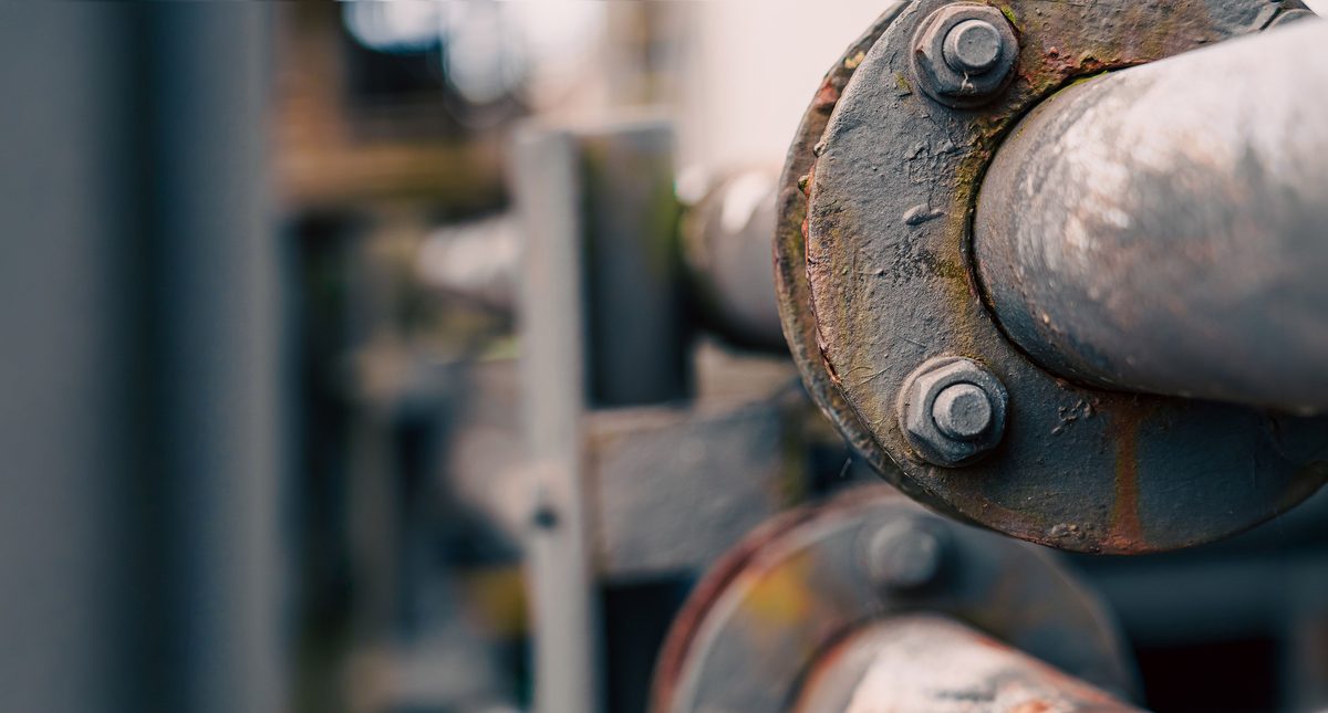 Industrial bolted flange joint close-up showing set screws and bolts